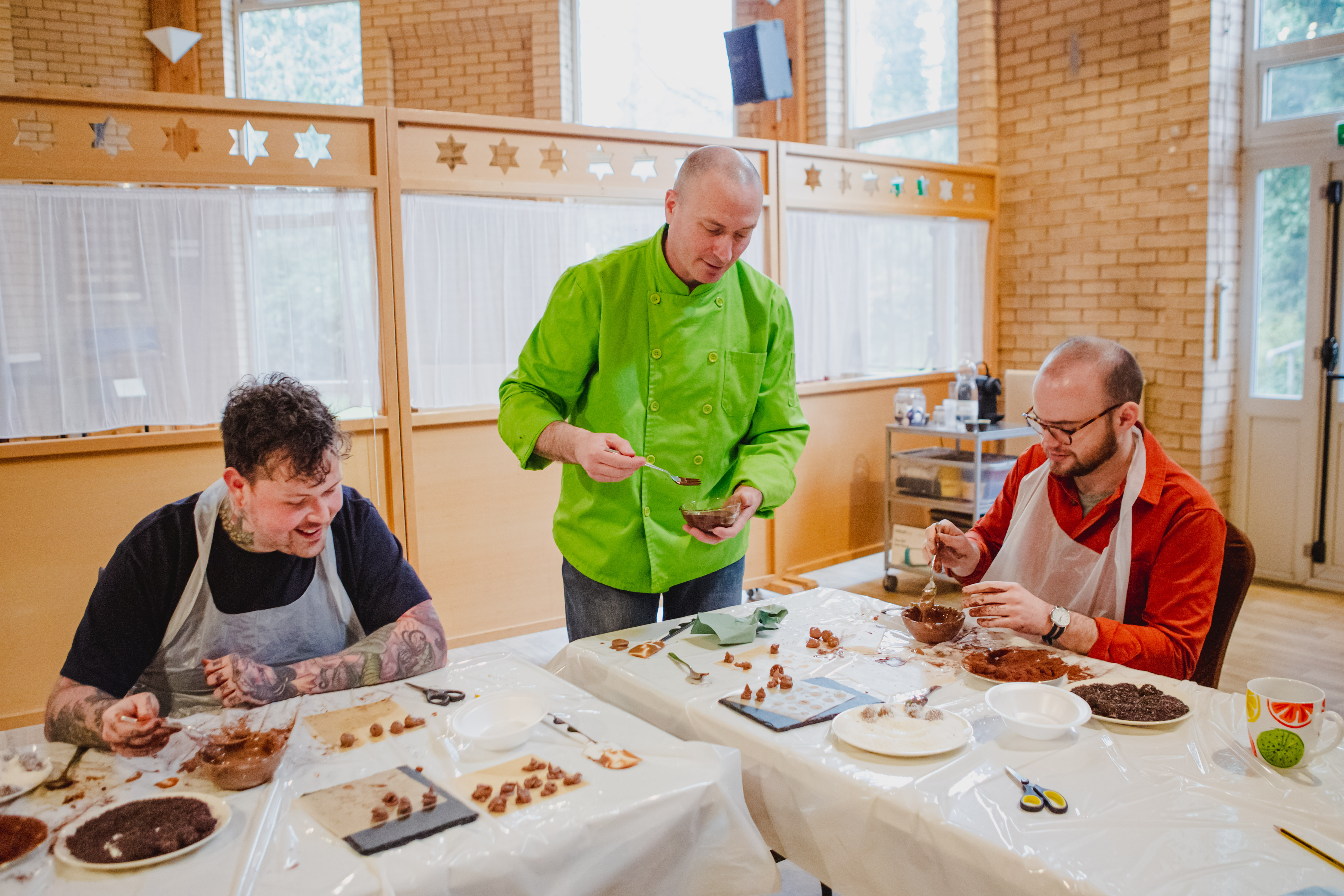 Couple making homemade chocolate truffles for Valentine's Day gift.